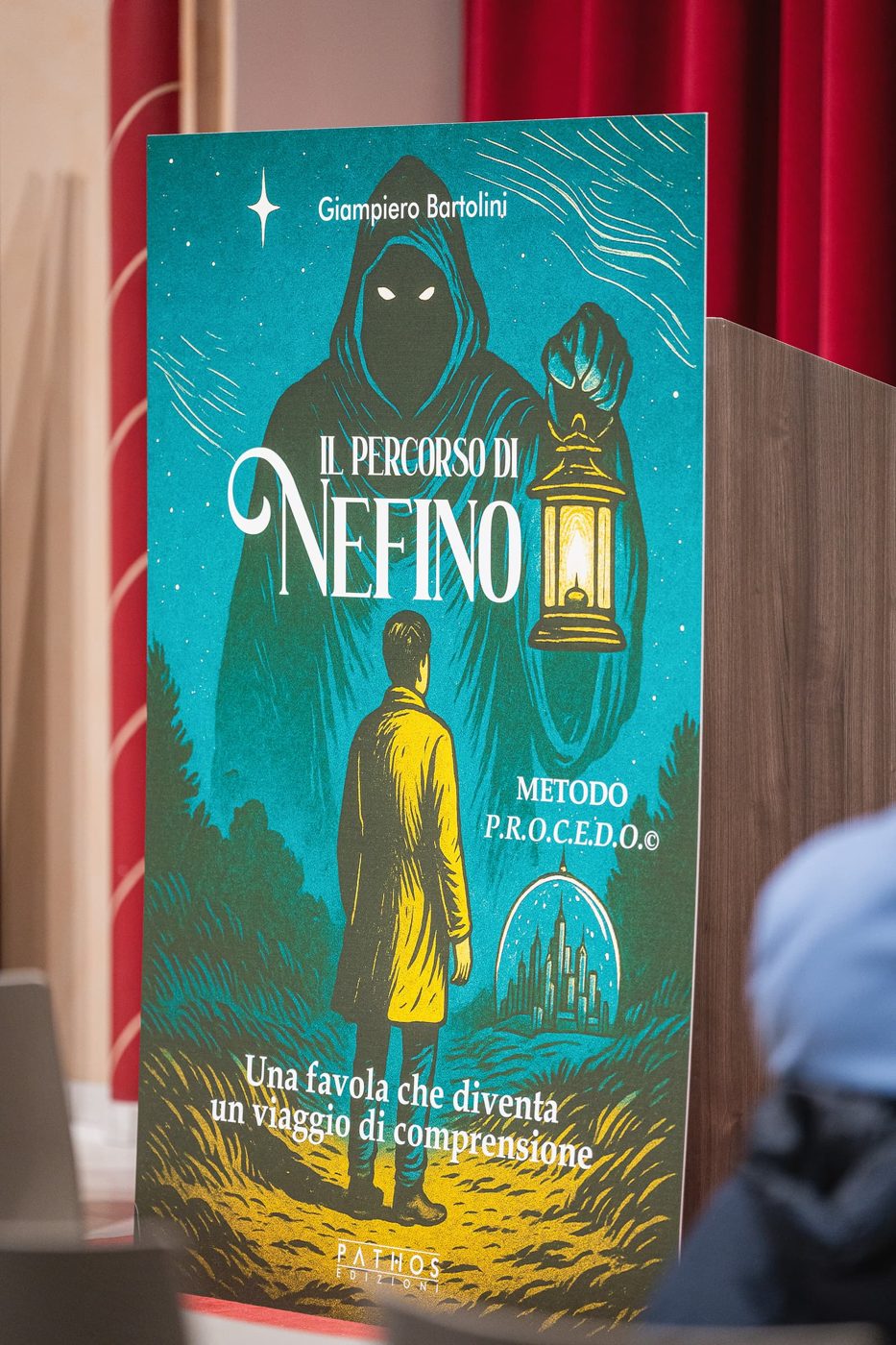 The book's roll-up banner at a presentation